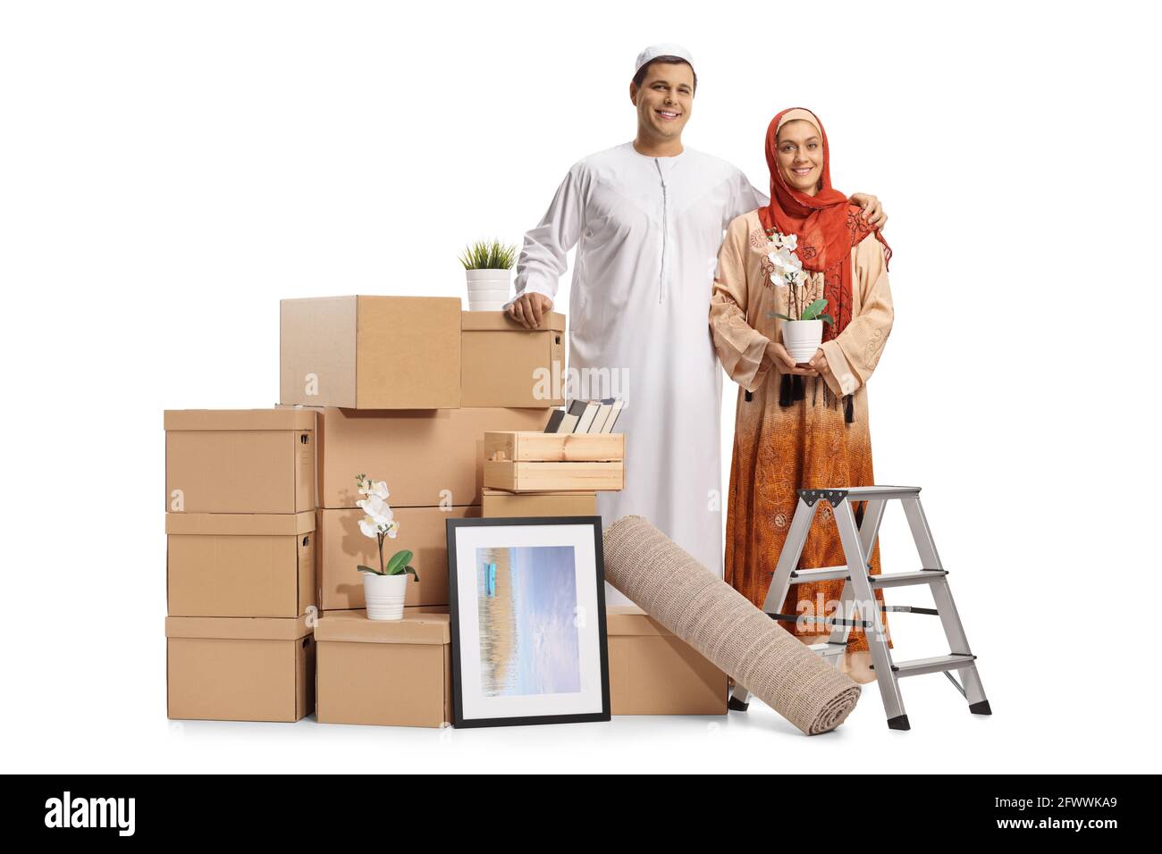 Young muslim couple packing for removal with a pile of cardboard boxes isolated on white background Stock Photo