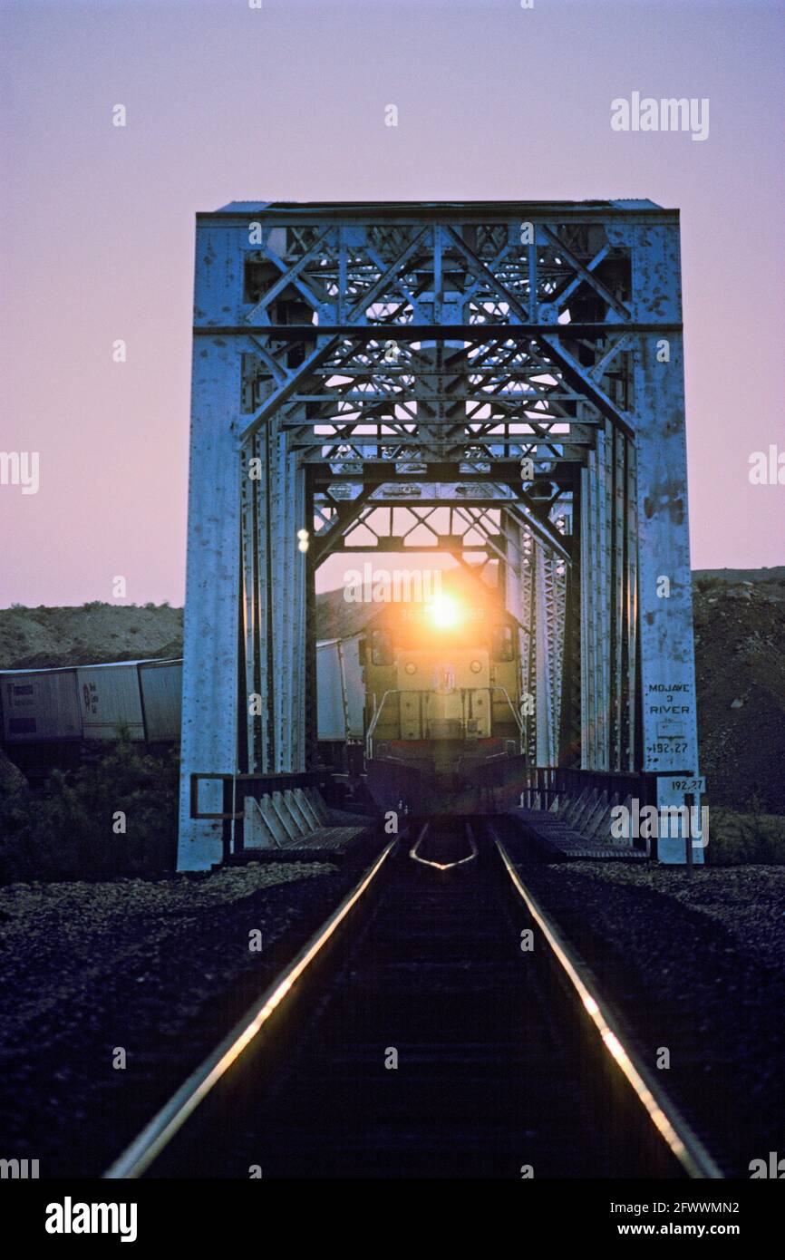 Iron Railroad Bridge; Train; Headlight At Dusk Stock Photo - Alamy