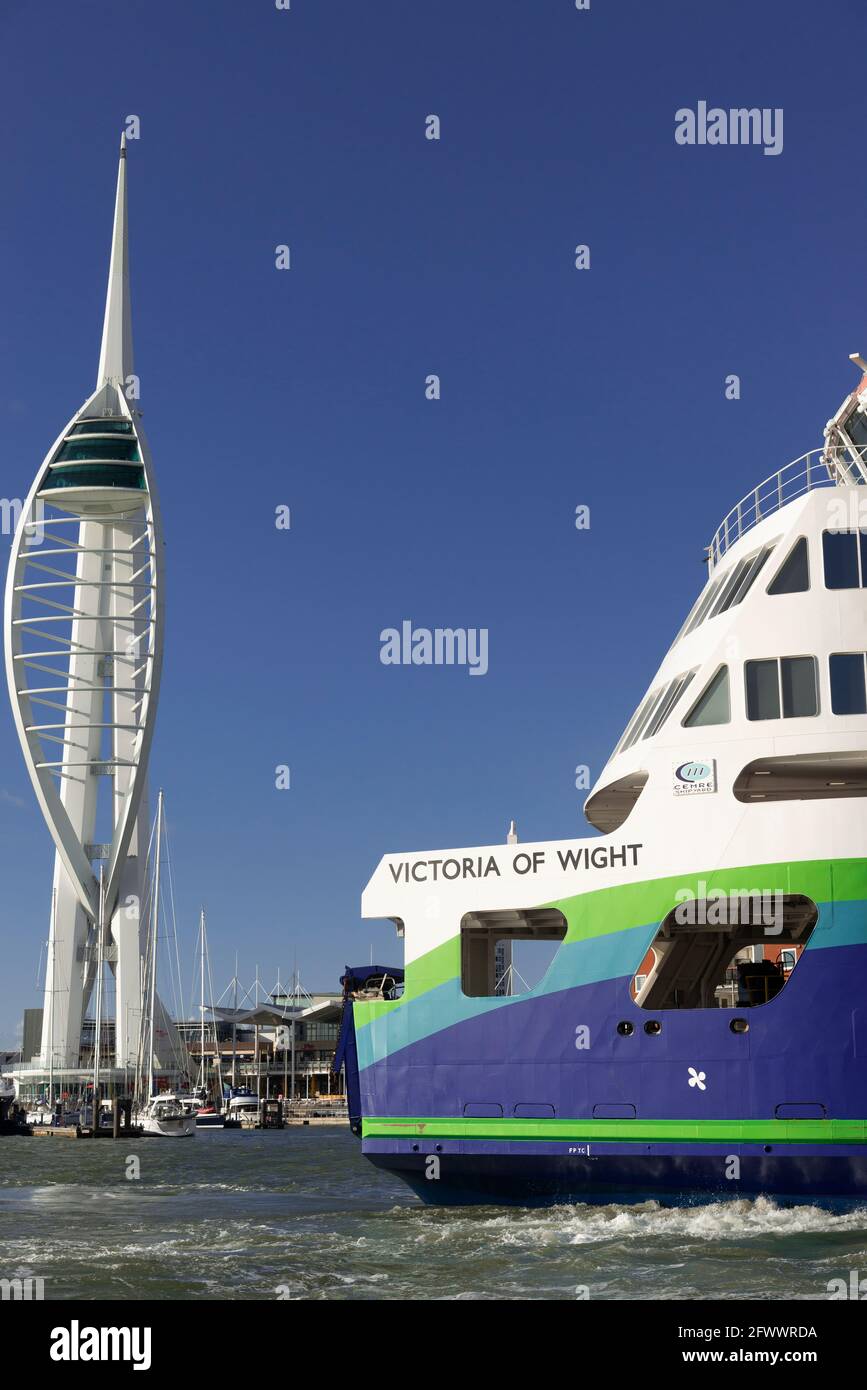 The hybrid energy Wightlink ferry 'Victoria of Wight' in Portsmouth Harbour with the Spinnaker Tower and Gunwharf Quays in the background-Hampshire,UK Stock Photo