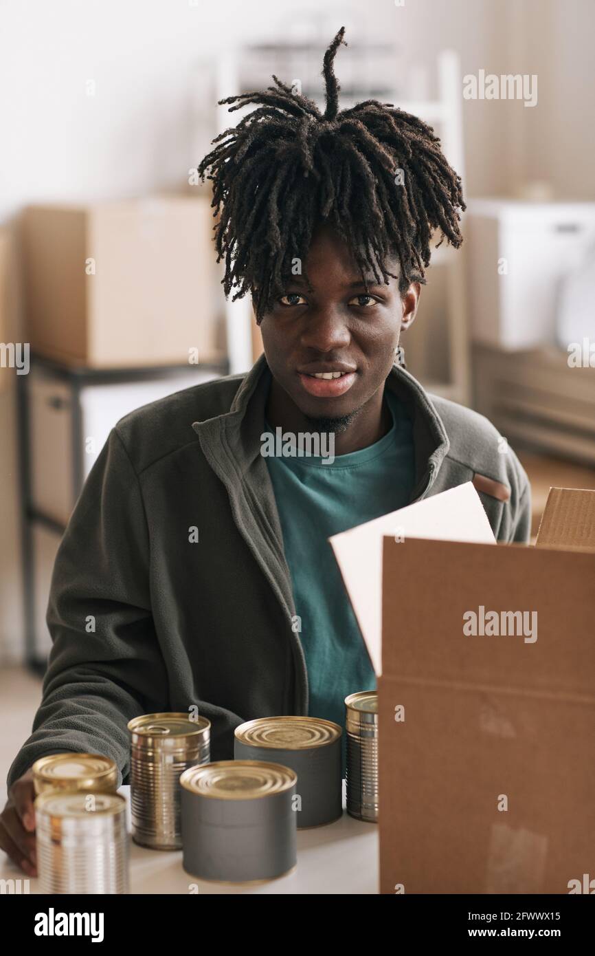Adult african man packing boxes hi-res stock photography and images - Alamy