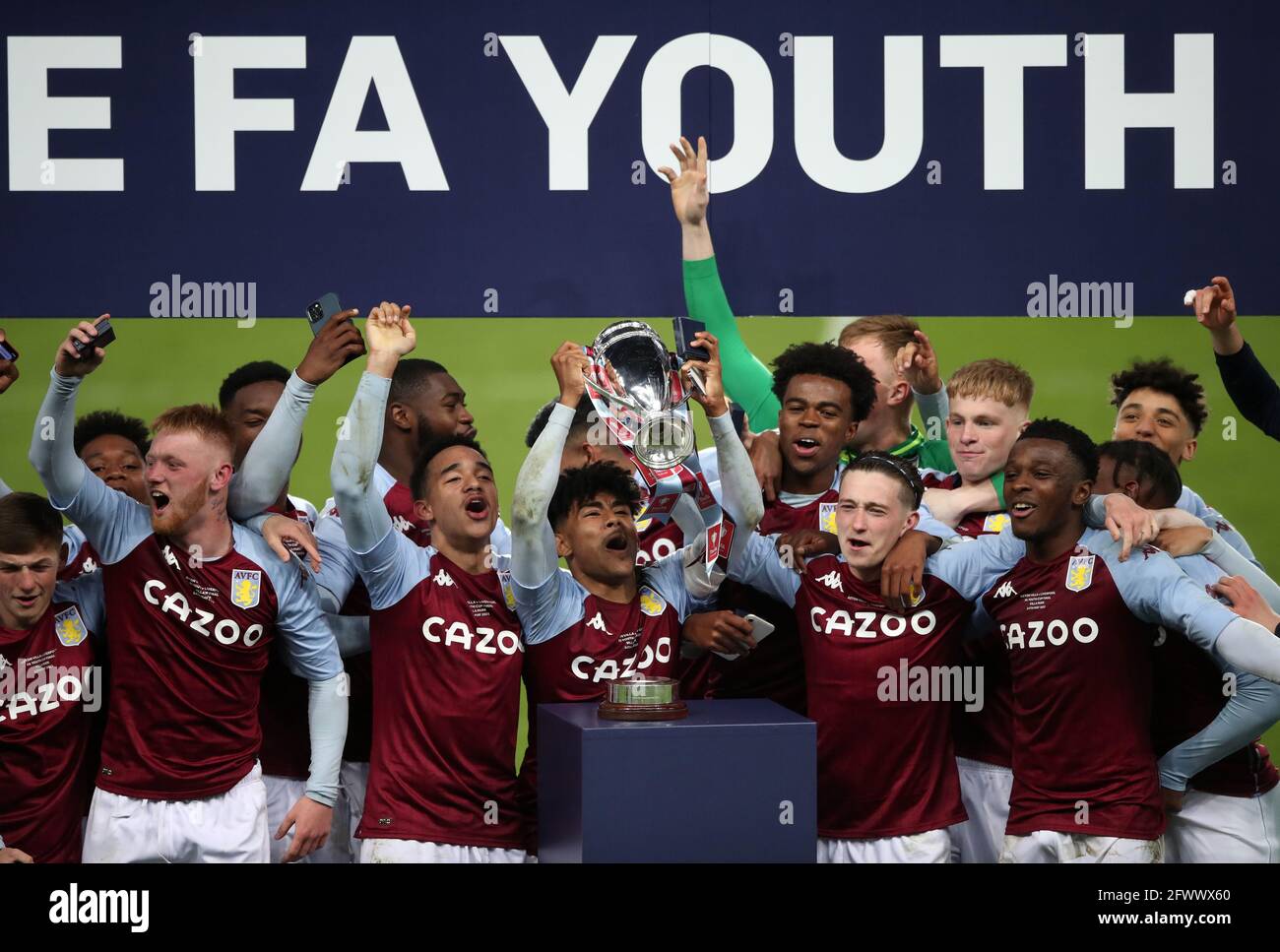 Aston Villa's Kaine Kesler Hayden holds the trophy as they celebrate