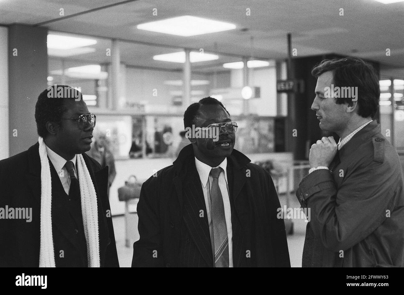 Professor Adebayo Adedeji, coming to give some lectures on the food problem in Africa, is welcomed at Schiphol Airport by J. Verloren van Themaat from the ISS, January 13, 1986, arrival and departure, greetings, professors, The Netherlands, 20th century press agency photo, news to remember, documentary, historic photography 1945-1990, visual stories, human history of the Twentieth Century, capturing moments in time Stock Photo