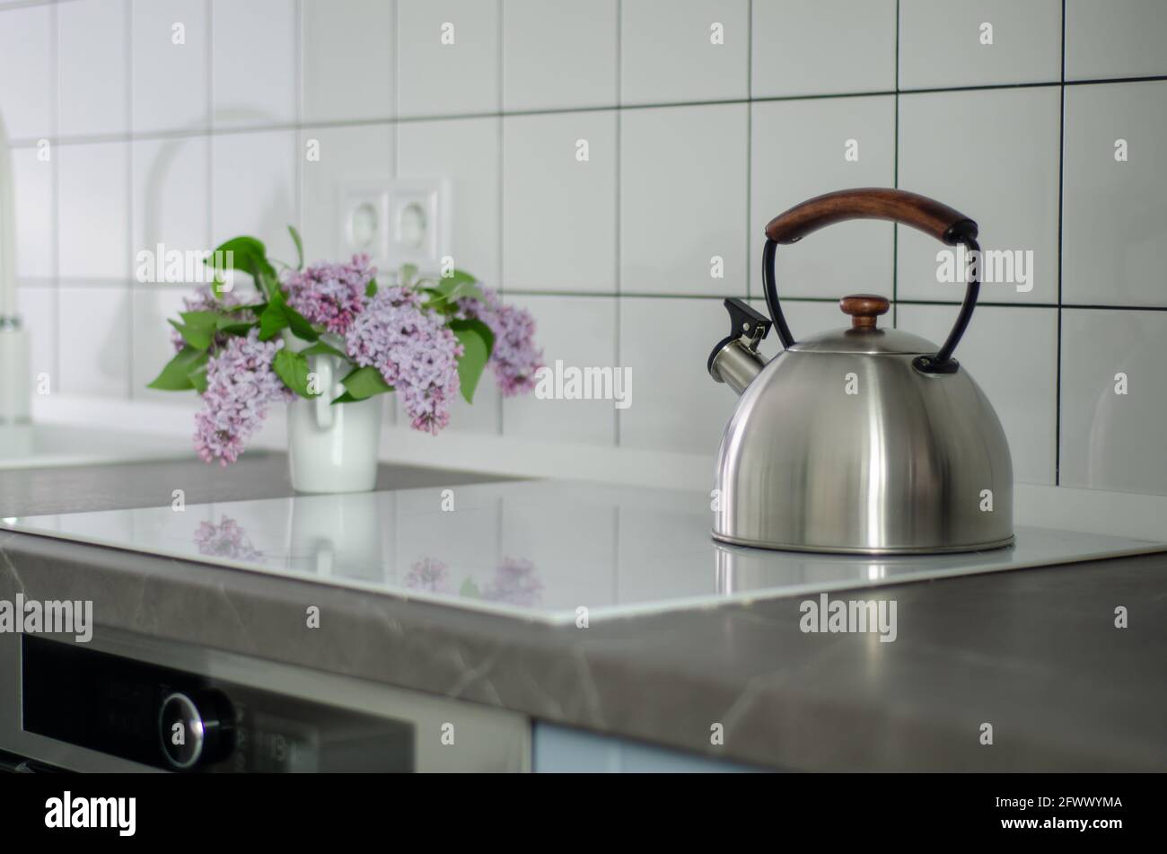 Steel kettle in modern kitchen with induction stove Stock Photo Alamy