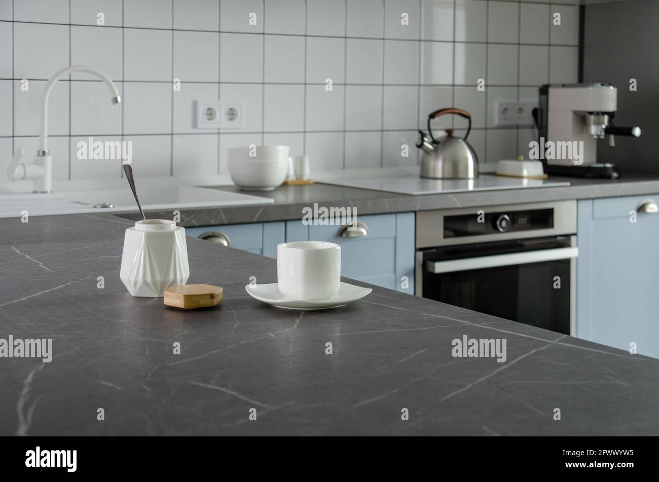 Modern stylish blue and gray kitchen with tea and coffee making