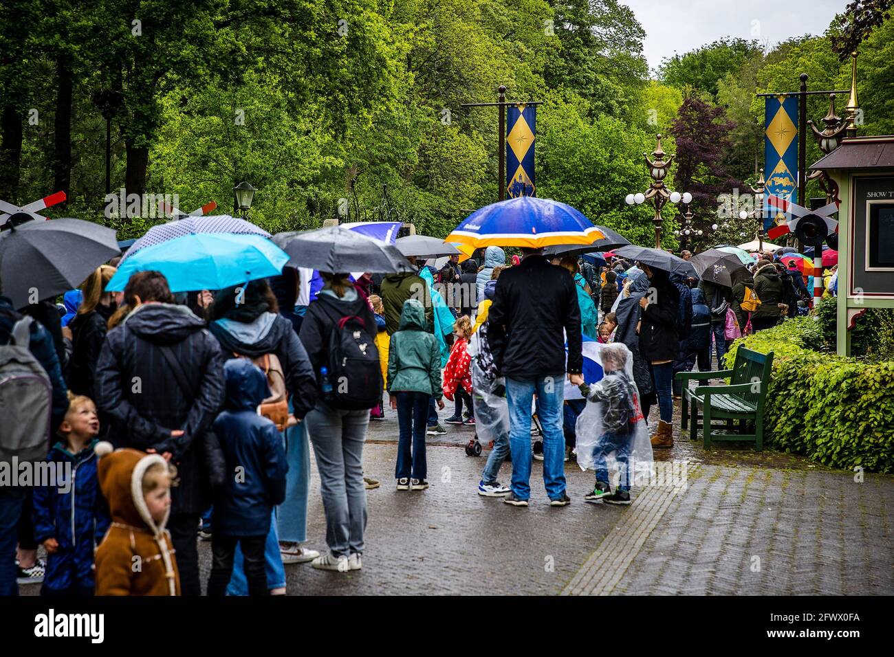 KAATSHEUVEL - 24-05-2021. Busy in Efteling on Whit Monday. Despite the  rain, many visitors came to the amusement park. Children, roller coaster,  attractions, baron, visitors, Brabant, crowded, efteling, kaatsheuvel,  spring, umbrella, park,