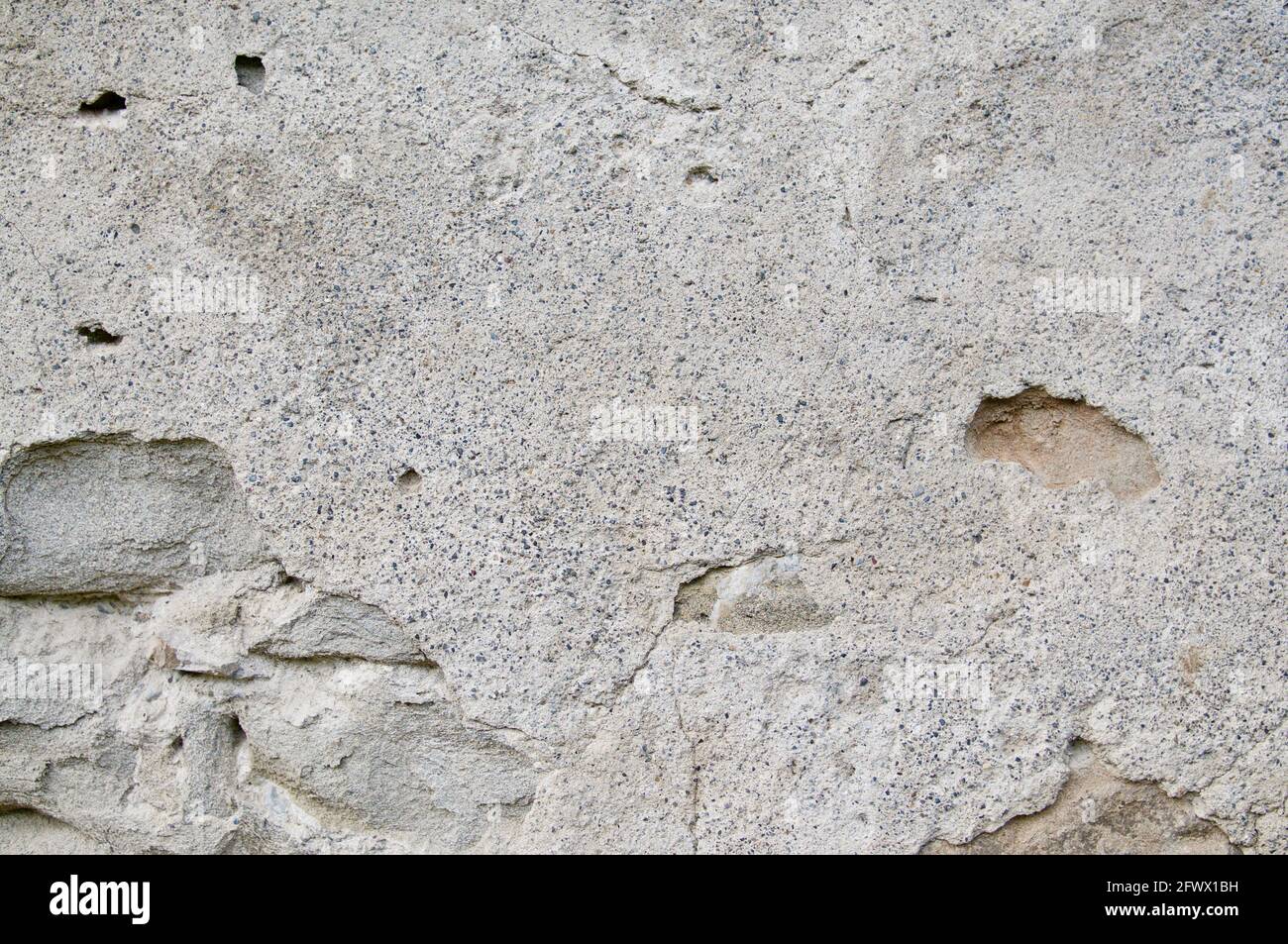 Aged grey street wall background with some cracks Stock Photo