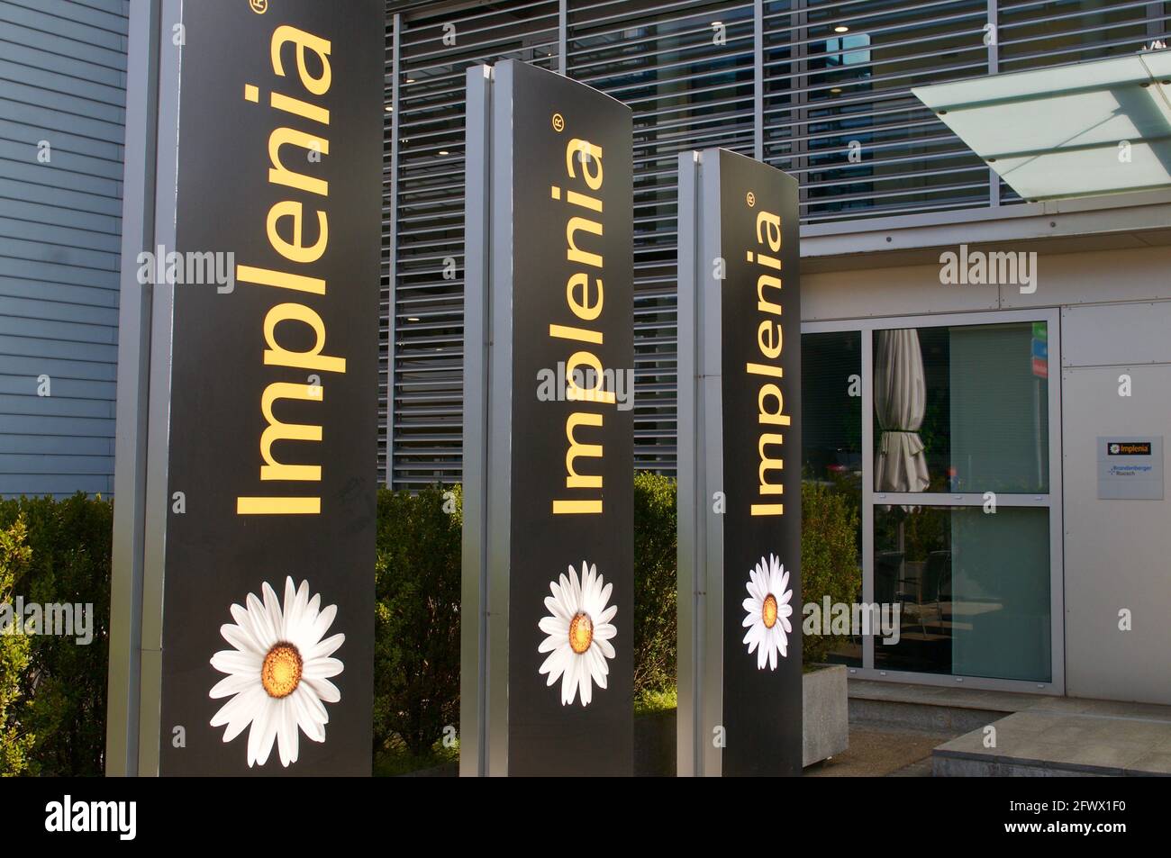 Dietlikon, Zurich, Switzerland - 16th April 2021 : Implenia company signs at the headquarters building in Dietlikon, Switzerland. Implenia is a Swiss Stock Photo