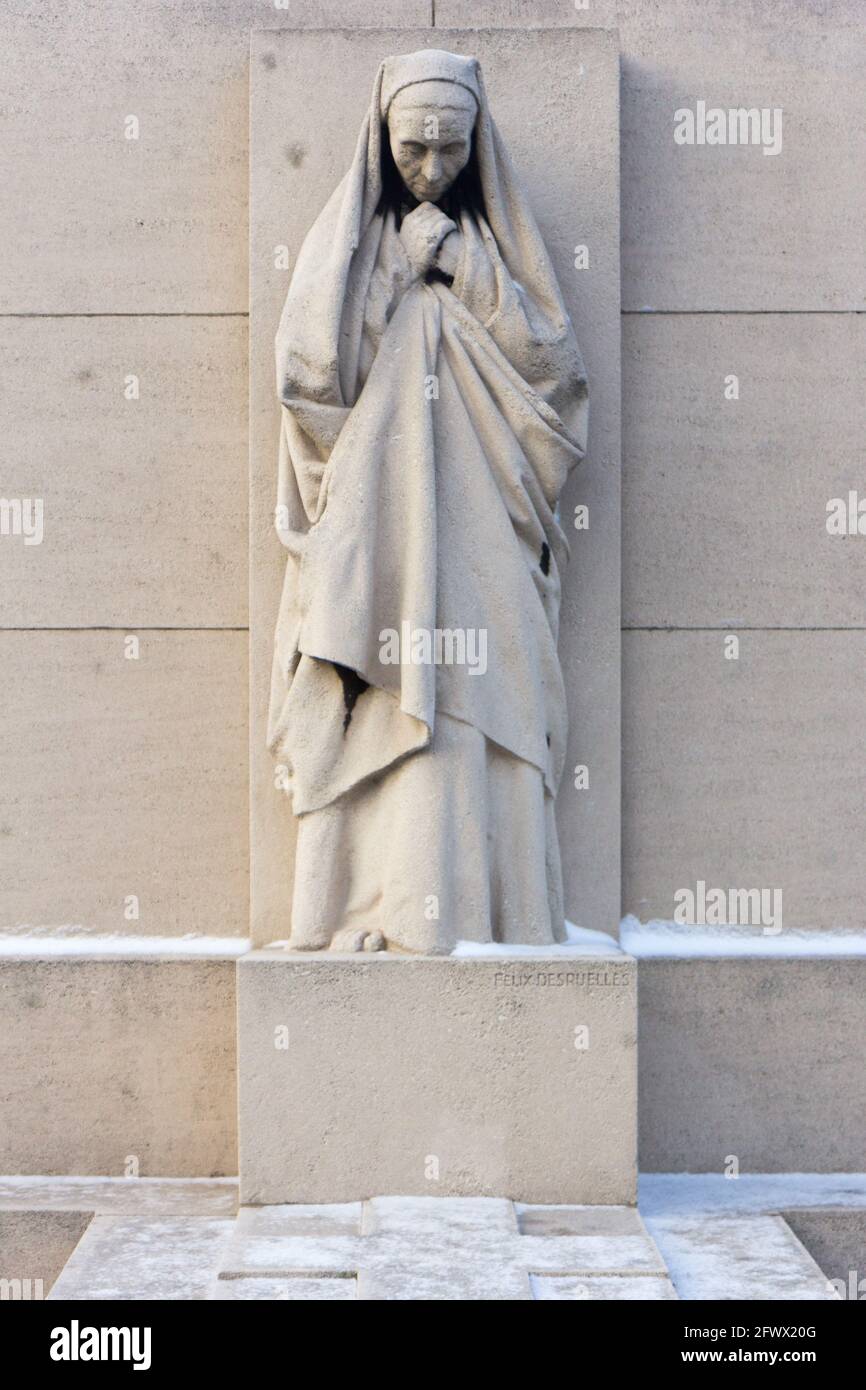 Valenciennes, France, 2017/01/02. Statue of a mourning woman on a tombstone at Saint Roch cemetery. Stock Photo