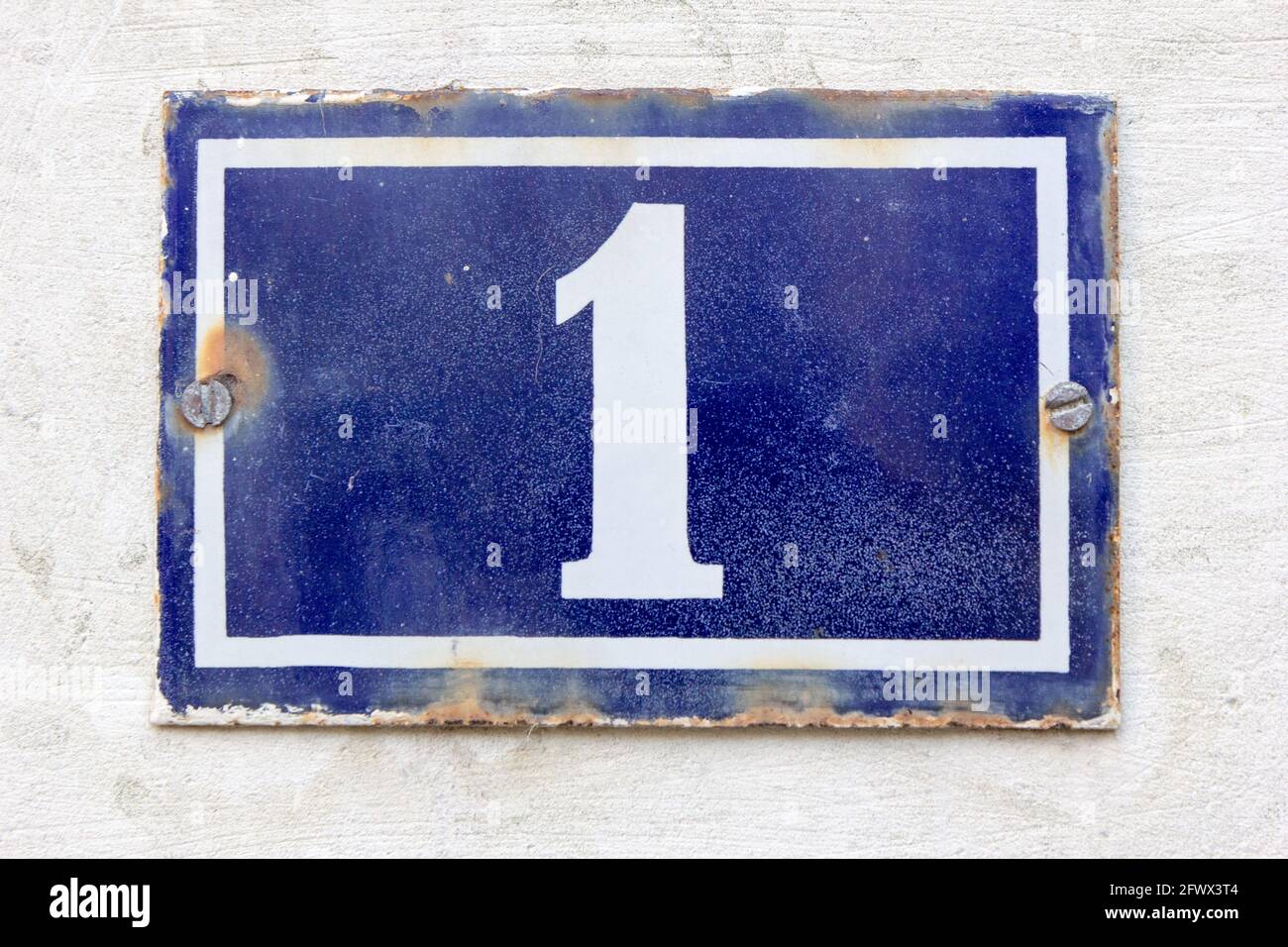 Number 1 (one) in white on a blue metal plate Stock Photo