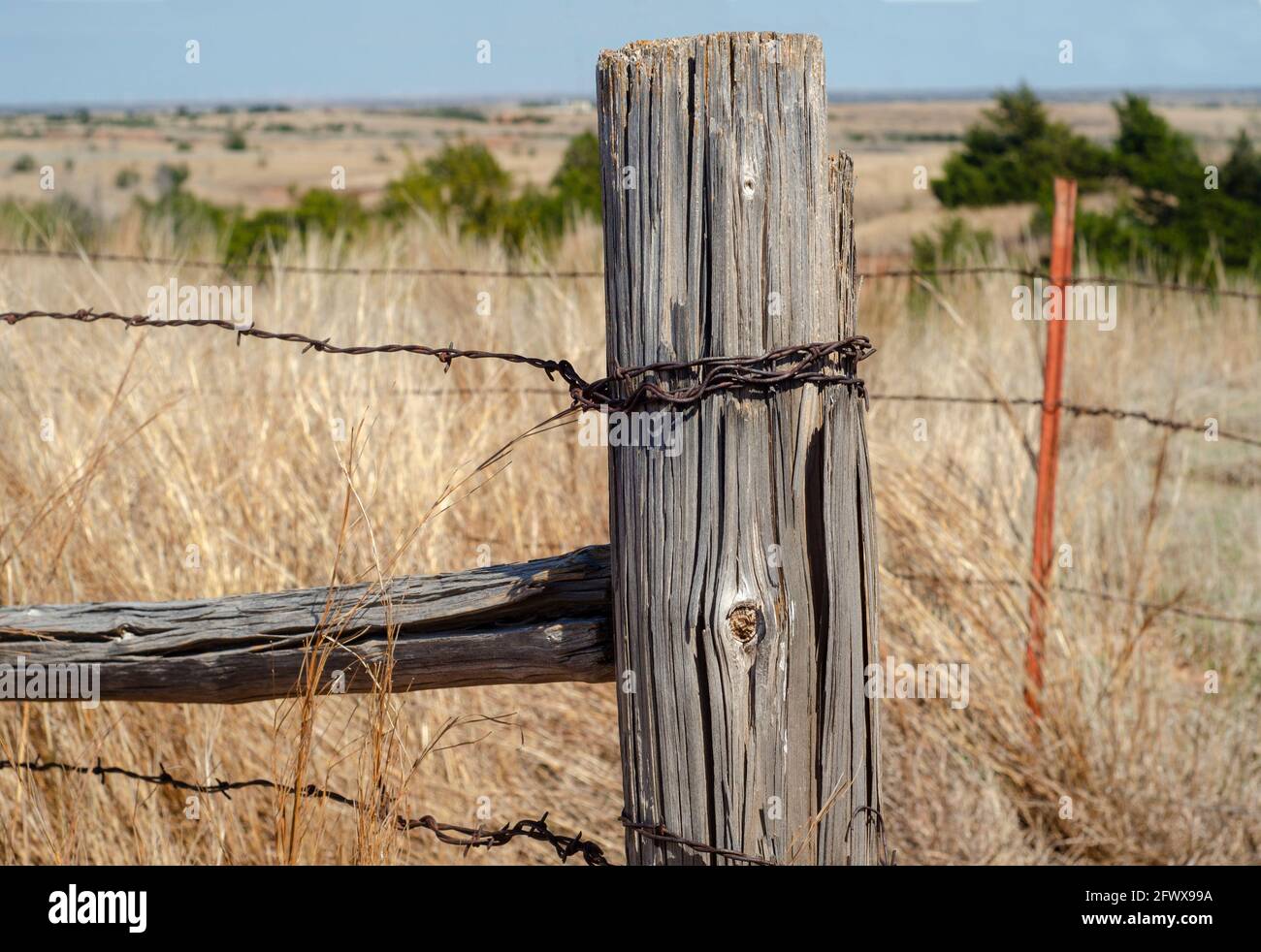 fence post and barbed wire on Kansas prairie Stock Photo