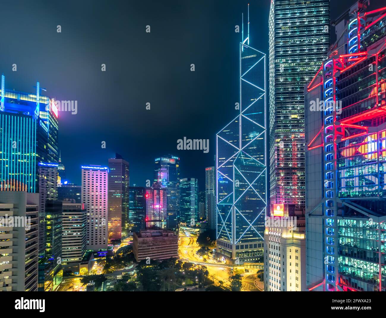 Hong Kong - 09 February 2018 - Rooftop View of Futuristic Dystopian City Skyline at Night with Neon Lights and Skyscrapers in Central Hong Kong Stock Photo