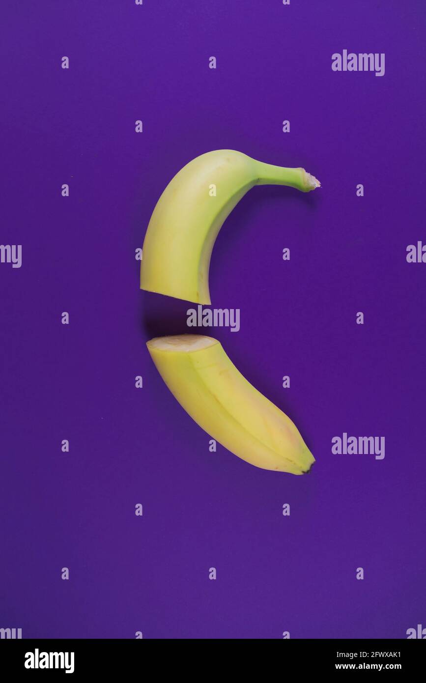 Sliced banana on trendy lavender background. Ultra violet color. Minimal abstract food and summer concept. With copy space. Stock Photo