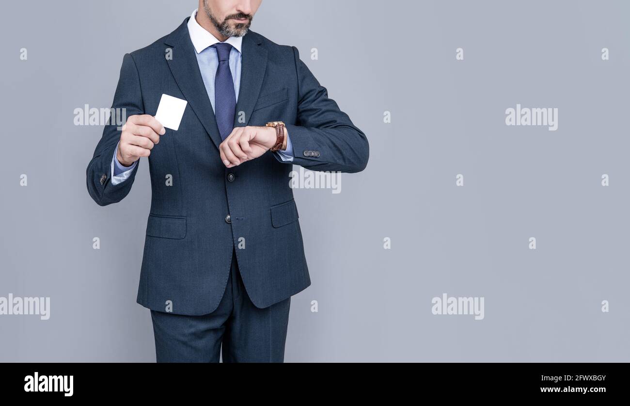 confident businessman man in suit showing debit card cheking time for copy space, fast payment Stock Photo
