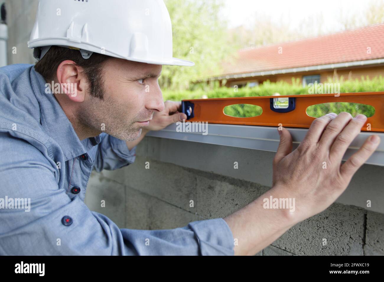 happy worker checks the level of a window Stock Photo - Alamy