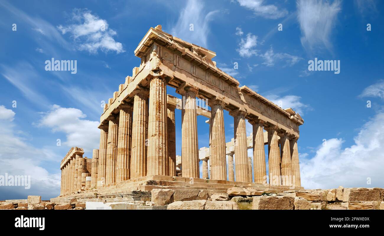 Acropolis, ancient Greek fortress in Athens, Greece. Panoramic image of Parthenon temple on a bright day with blue sky and feather clouds. Classical Stock Photo