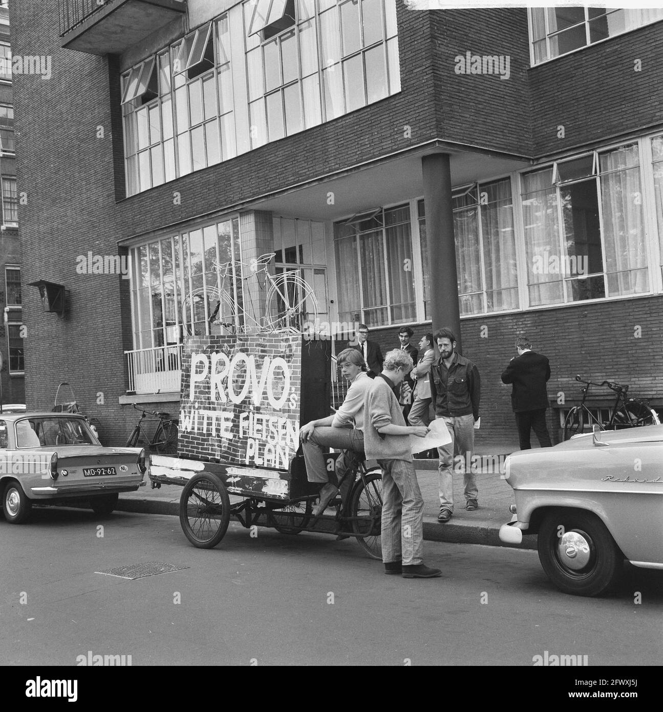 Provos at chief of police, provo cargo bike, August 14, 1965, bicycles, chief of police, police, protest movements, The Netherlands, 20th century pres Stock Photo