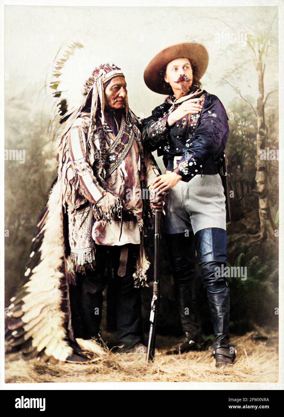 1880 ca , Montreal , CANADA : The celebrated Colonel William Frederick CODY , know as BUFFALO BILL ( 1846 - 1917 ) with Chef SITTING BULL ( 1831 - 1890 ) of Sioux Hunkpapa at  time of WILD WEST SHOW . Photo by W.M. Notman & Son , Montreal . DIGITALLY COLORIZED . - Epopea del Selvaggio WEST - cowboy - cow-boy  -  Circus - uomo anziano vecchio - older man  - baffi - barba - beard - moustache - Circo - hat - cappello - piume - feathers - Indians of America - Indiani d'America - Native Americans - Nativi americani - Pellerossa - Redskins - fucile - rifle - gun - arma - boots - stivali --- Archivio Stock Photo