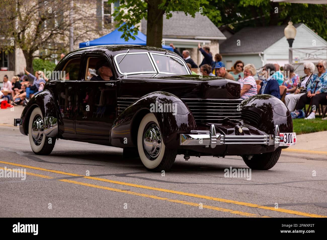 An antique Cord sedan classic automobile cruises through Auburn, Indiana as part of the 2019 Auburn Cord Duesenberg Festival Parade. Stock Photo