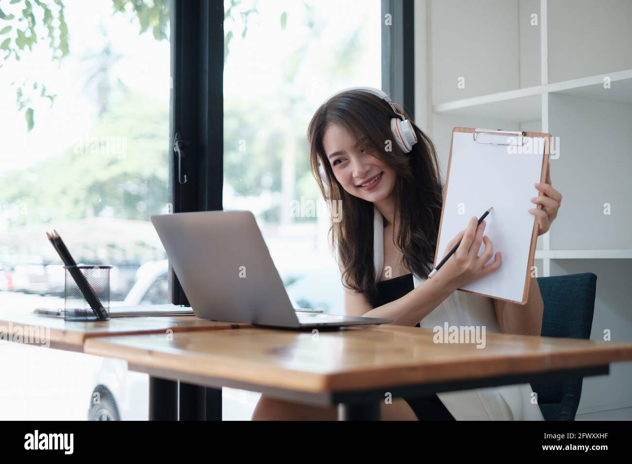 I have a question. Business woman show the question while online conference by laptop. Business and Entrepreneurship event Stock Photo