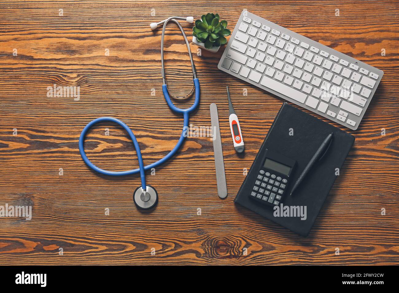 Composition with modern stethoscope and computer keyboard on wooden ...