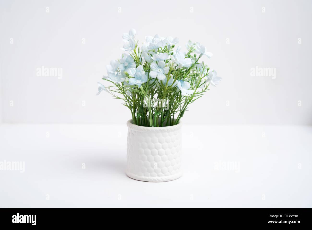 Fake flower pots in a vase on white background, Plastic flower Stock Photo