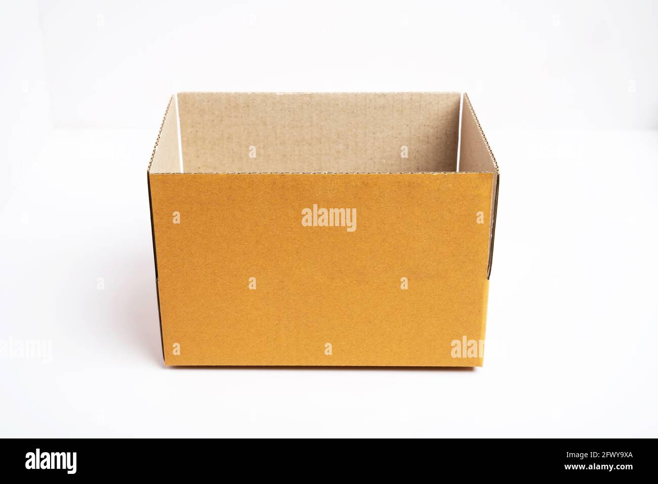 Side view of open brown cardboard box on white background Stock Photo ...