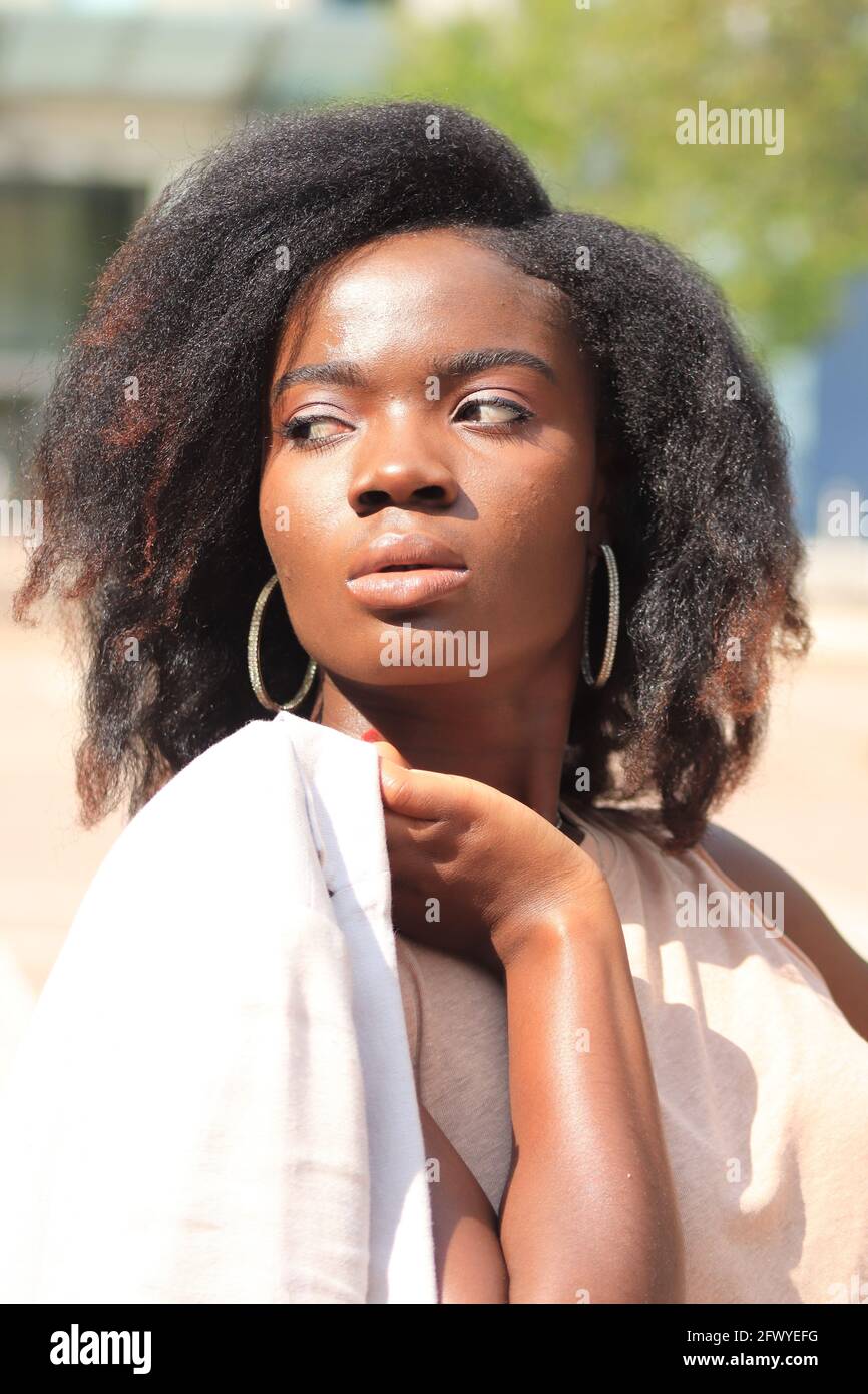 Attractive model looking at camera, close up portrait, one person, natural african model, african american model, background, outdoor portrait, lookin Stock Photo