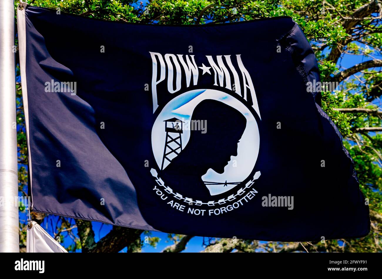 A POW-MIA flag for Prisoners of War and soldiers Missing in Action flies,  May 8, 2021, at Guice Park in Biloxi, Mississippi. Stock Photo