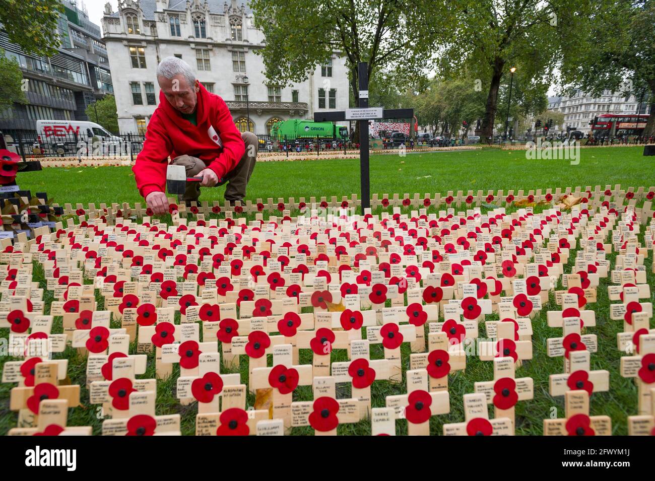 Chris McVeigh a worker at The Poppy Factory laying out some 100,000 crosses which make up annual The Field of Remembrance at Westminster Abbey. The Po Stock Photo
