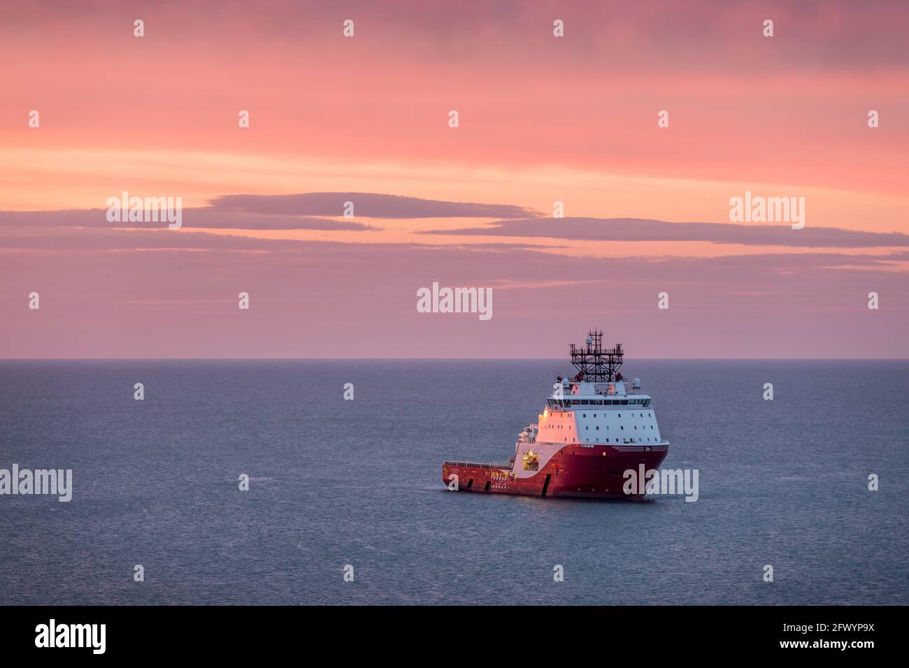 Myrtleville, Cork, Ireland. 25th May, 2021. Norwegian registered offshore supply ship Siam Diamond lies at anchor at dawn off Myrtleville, Co. Cork. The tug is one of the vessels taking part in the decommissioning of the Kinsale gas field.- Credit; David Creedon / Alamy Live News Stock Photo