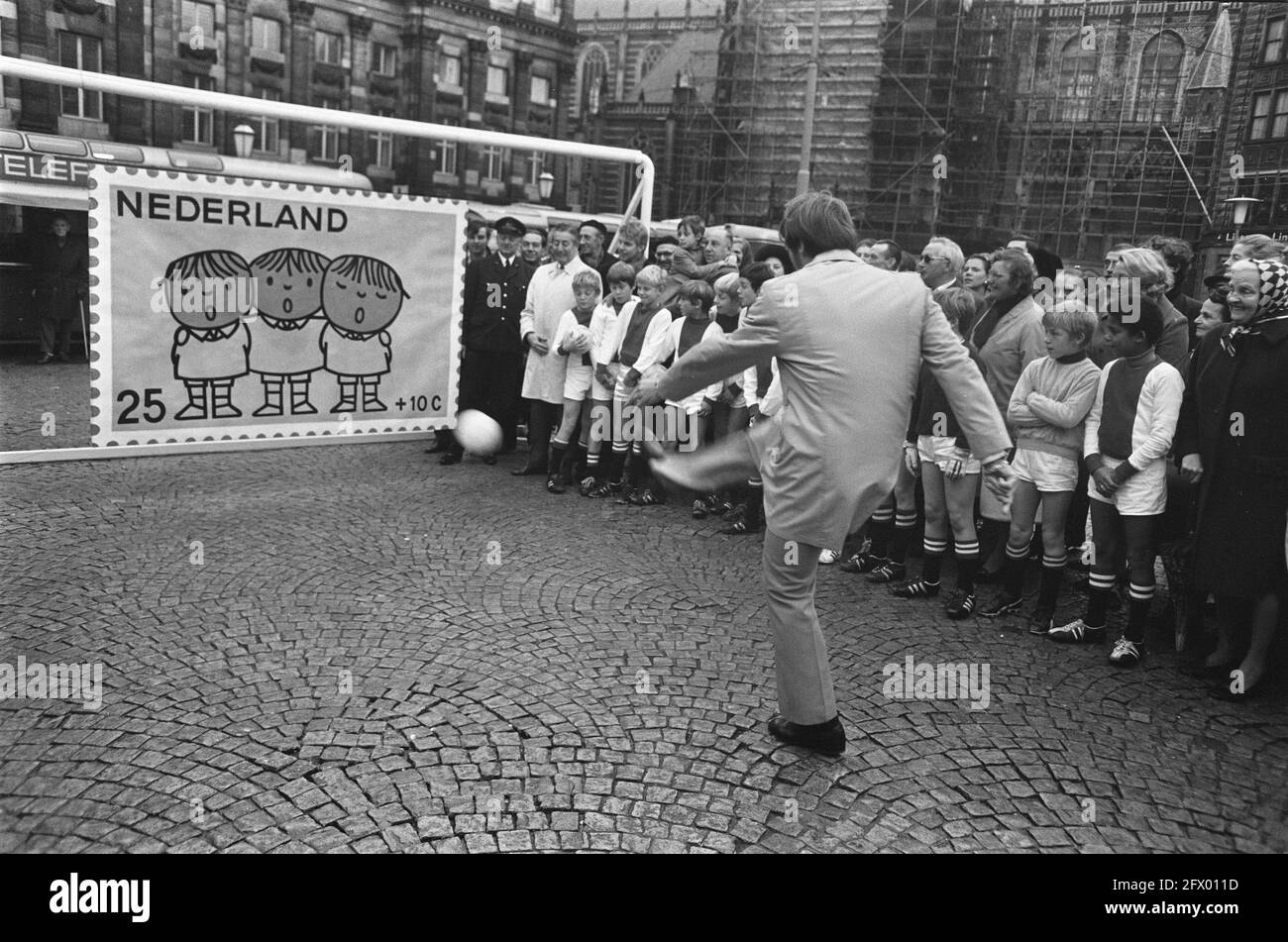 Ruud Krol, Ajax footballer, starts children's stamp campaign on Dam Square Amsterdam. Ruud Krol shoots, November 11, 1969, ACTIONS, CHILDREN'S POSTAGE STAMPS, The Netherlands, 20th century press agency photo, news to remember, documentary, historic photography 1945-1990, visual stories, human history of the Twentieth Century, capturing moments in time Stock Photo