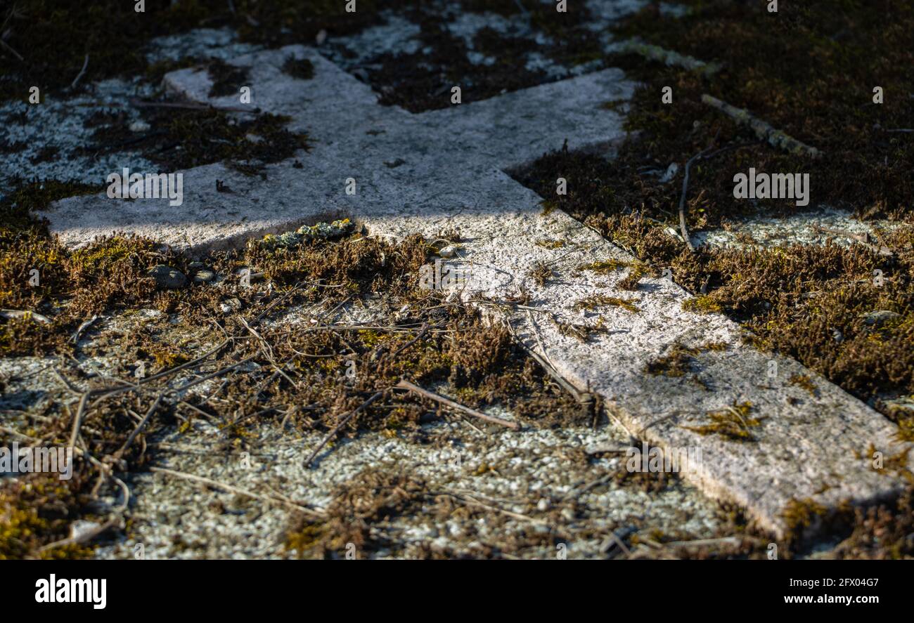 A stone cross on a tombstone in a cemetery Stock Photo Alamy