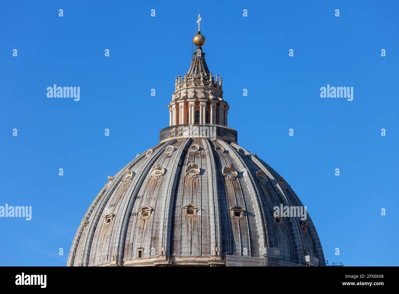 Vatican, iconic dome of the Papal Basilica of Saint Peter isolated against blue sky. Stock Photo