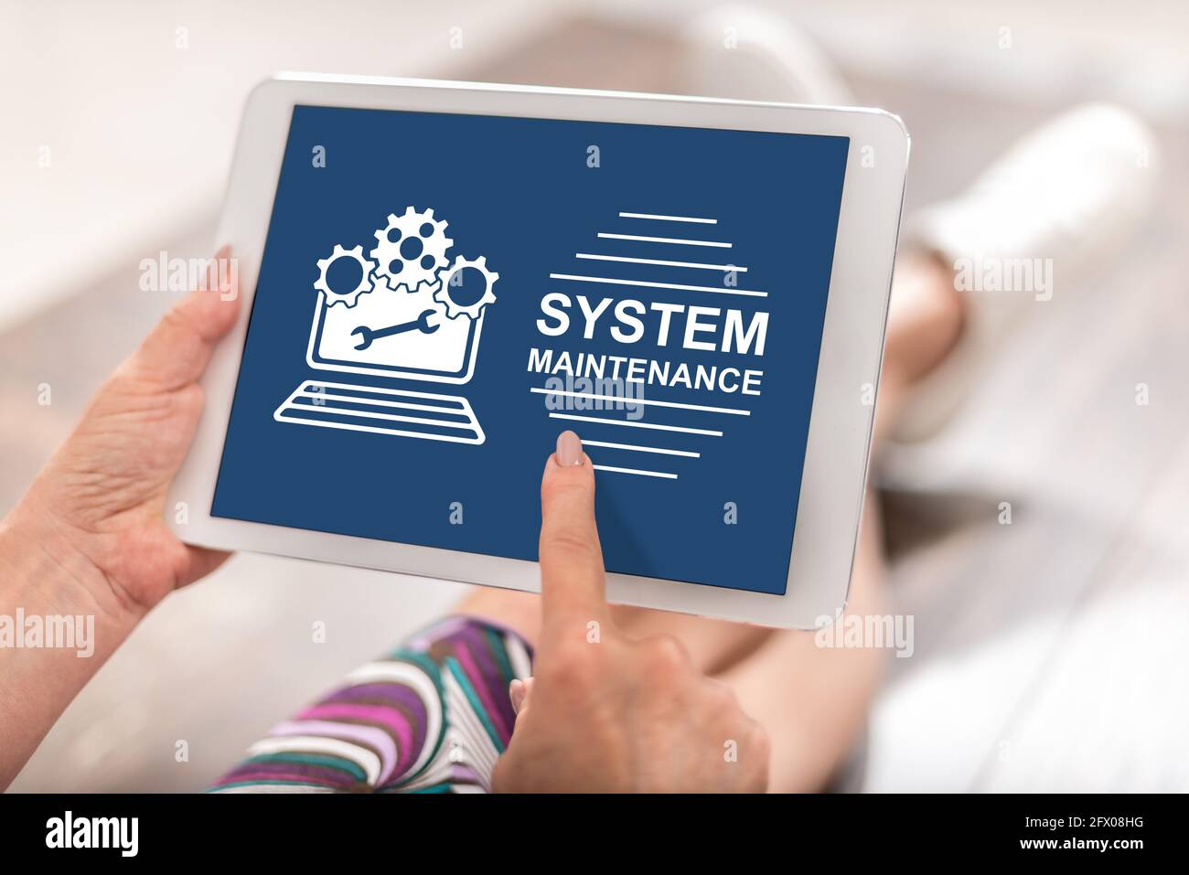Woman using a tablet with system maintenance concept Stock Photo