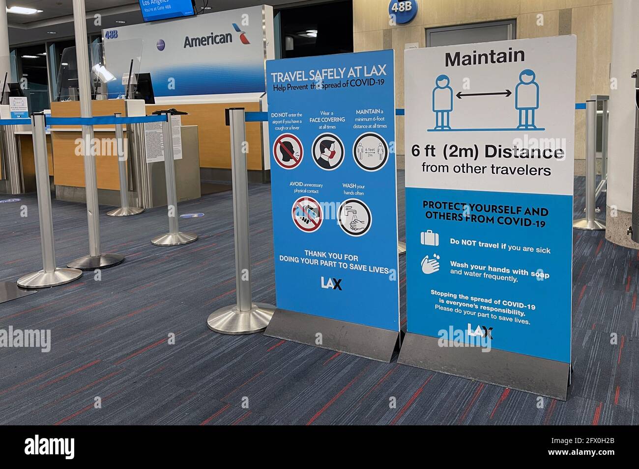 COVID-19 safety travel advisories signs at Gate 48B of Terminal 4 of the Los Angeles International Airport, Tuesday, May 24, 2021, in Los Angeles. Kir Stock Photo