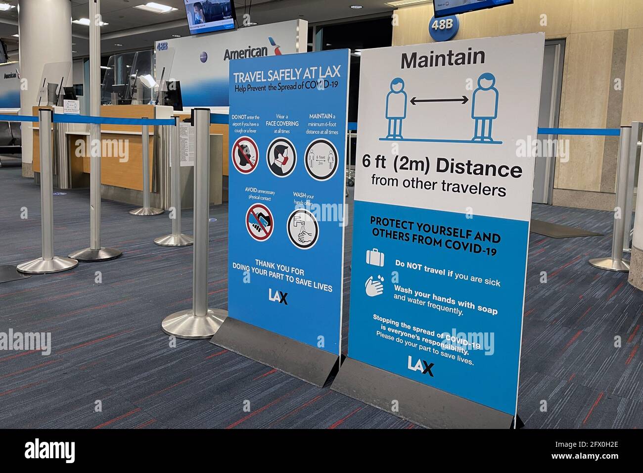 COVID-19 safety travel advisories signs at Gate 48B of Terminal 4 of the Los Angeles International Airport, Tuesday, May 24, 2021, in Los Angeles. Kir Stock Photo