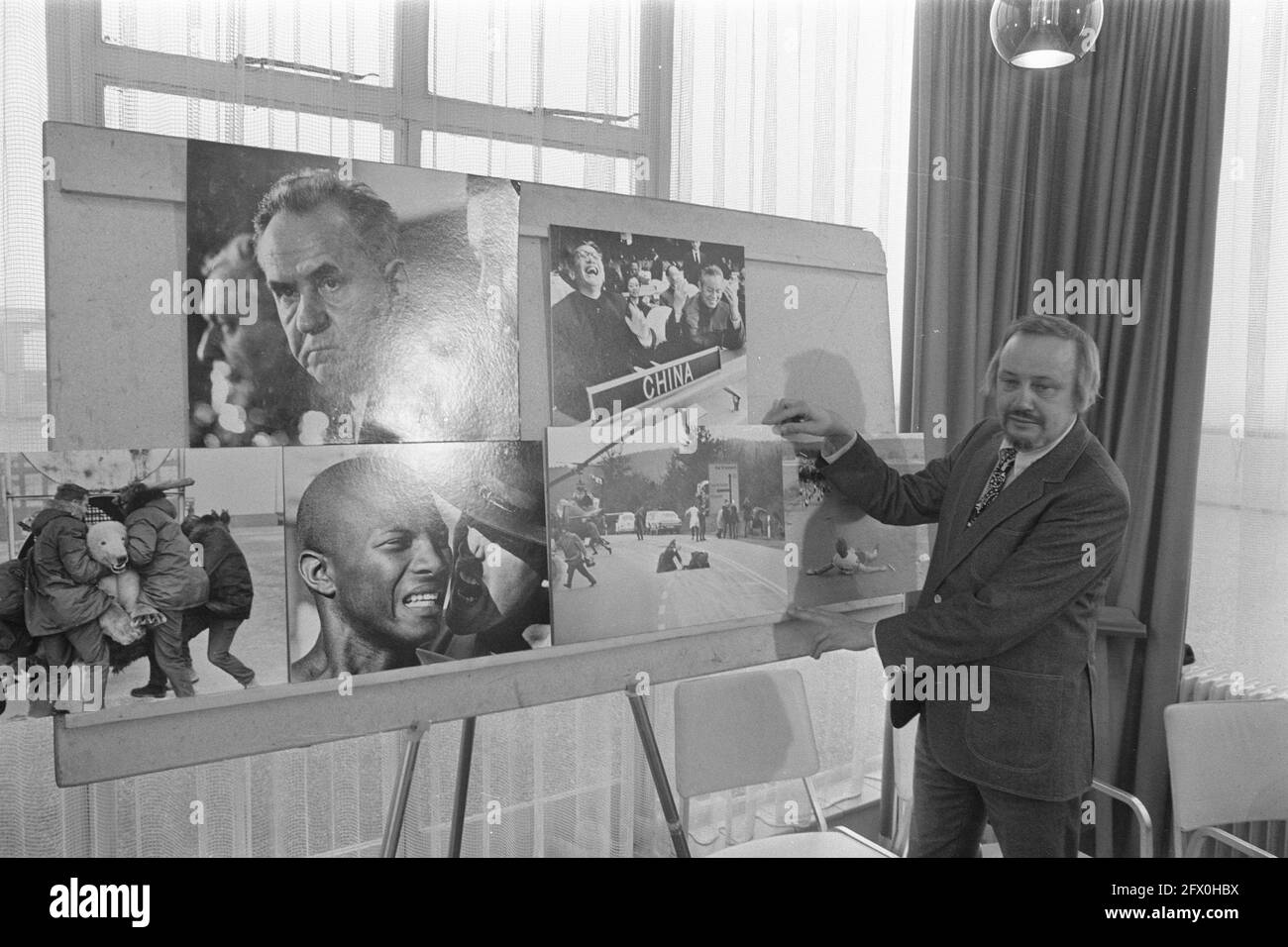 World Press Photo 1972, jury president Joop Swart holds up winning photo shot bank robber during press conference at Hilton hotel in Amsterdam, February 24, 1972, photography, press conferences, The Netherlands, 20th century press agency photo, news to remember, documentary, historic photography 1945-1990, visual stories, human history of the Twentieth Century, capturing moments in time Stock Photo