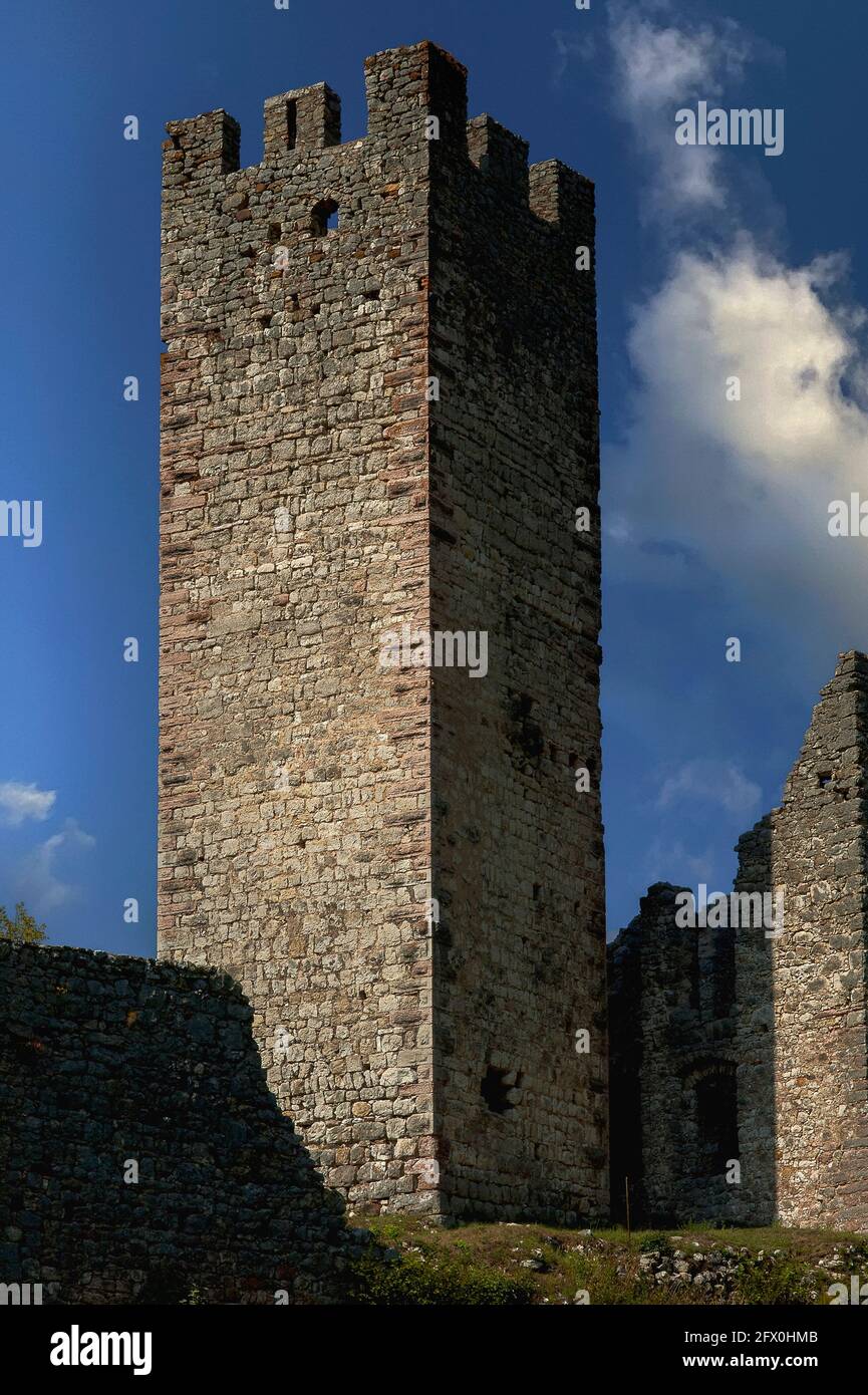 A medieval watchtower of 1311 rises above the ruins of Castel Belfort at Spormaggiore, Trentino-Alto Adige, Italy.  The watchtower and castle were originally built to guard the entrance to the Val de Non and the Brenta Dolomites.  The castle was rebuilt after a devastating fire in 1670 and then abandoned in the late 1700s. Stock Photo