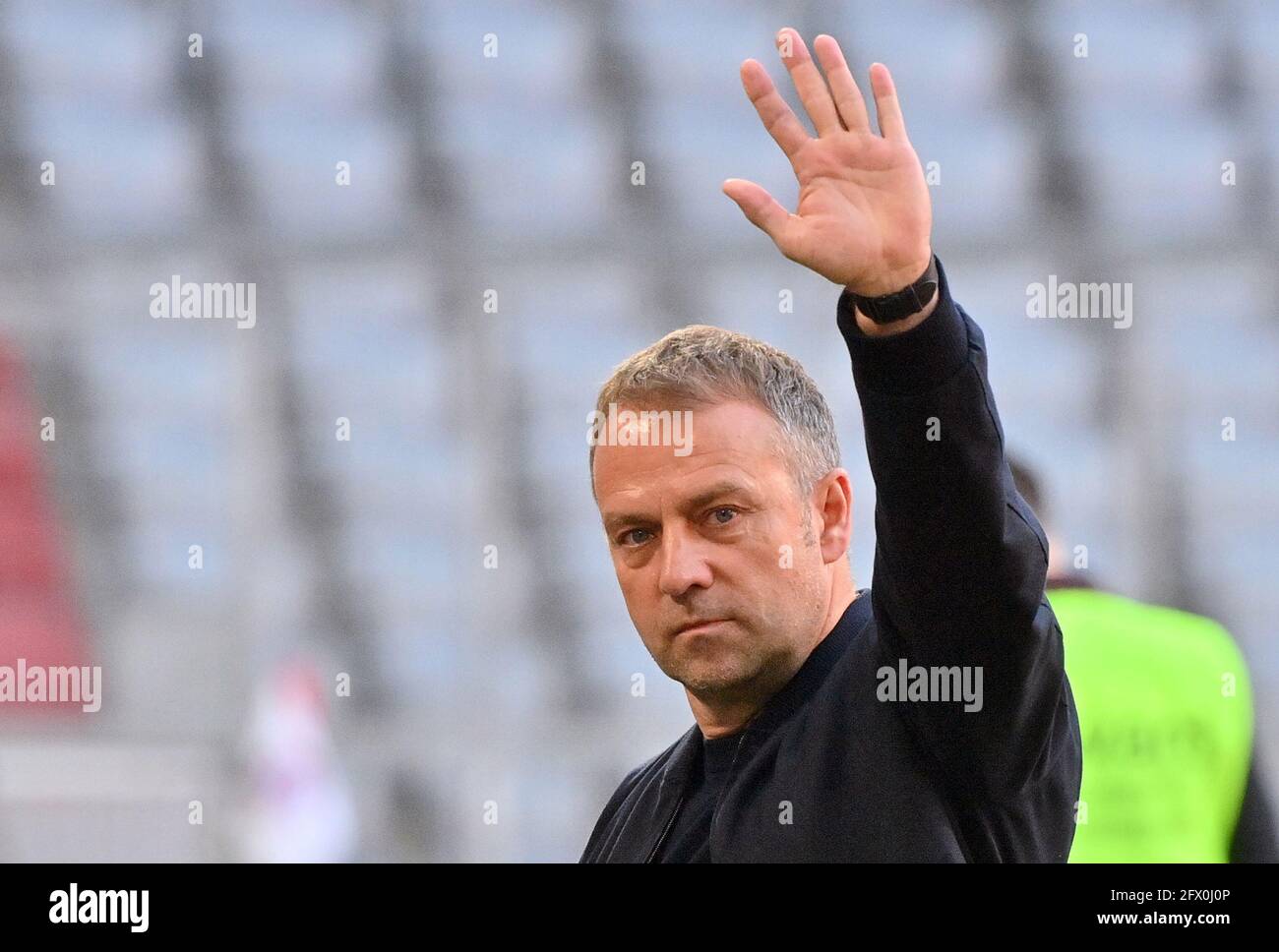 Munich, Germany. 08th May, 2021. Football: Bundesliga, FC Bayern München - Borussia Mönchengladbach, matchday 32 at the Allianz Arena. Munich's current coach Hansi Flick is waving. According to a report in the newspaper 'Bild', Flick is expected to sign a contract today, Tuesday, as the new national coach after the European Soccer Championship. According to the paper, the working paper of the 56-year-old former co-trainer of Löw will be valid until after the home European Championship in 2024. Credit: Peter Kneffel/dpa-Pool/dpa/Alamy Live News Stock Photo