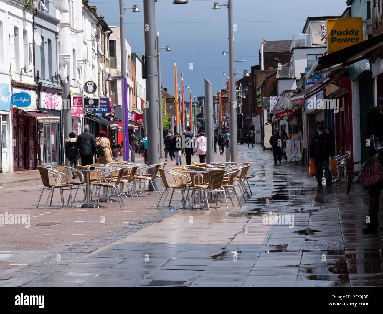 Quiet and empty Walthamstow High Street, London, empty chairs outside cafe during the Covid-19 coronavirus pandemic Stock Photo