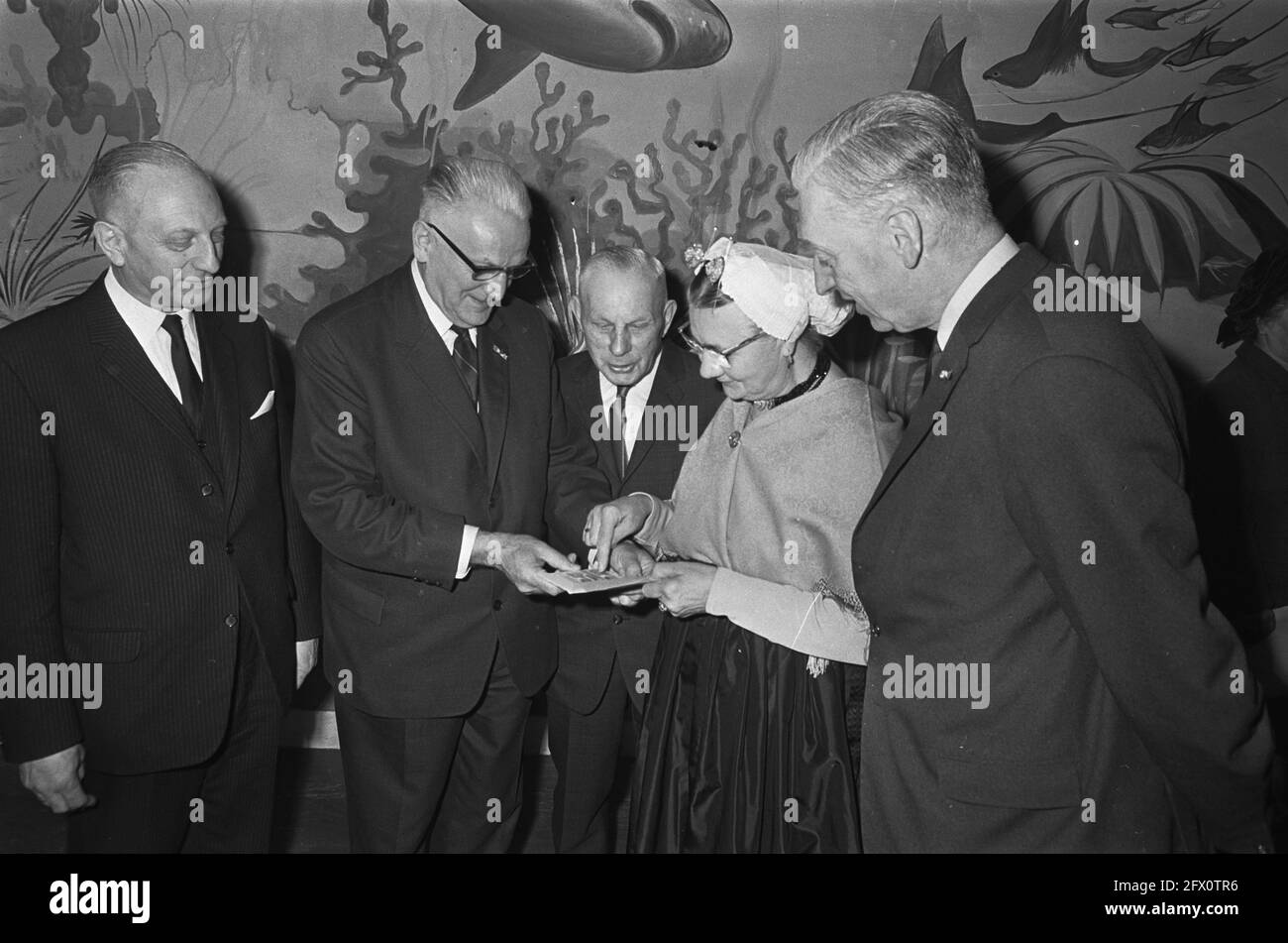 Summer postage stamps 1967, Director-General of the PTT prof. ir. G. H. Bast gives first stamps to Mrs. P. Taal-Bal, April 11, 1967, philately, costumes, stamps, The Netherlands, 20th century press agency photo, news to remember, documentary, historic photography 1945-1990, visual stories, human history of the Twentieth Century, capturing moments in time Stock Photo