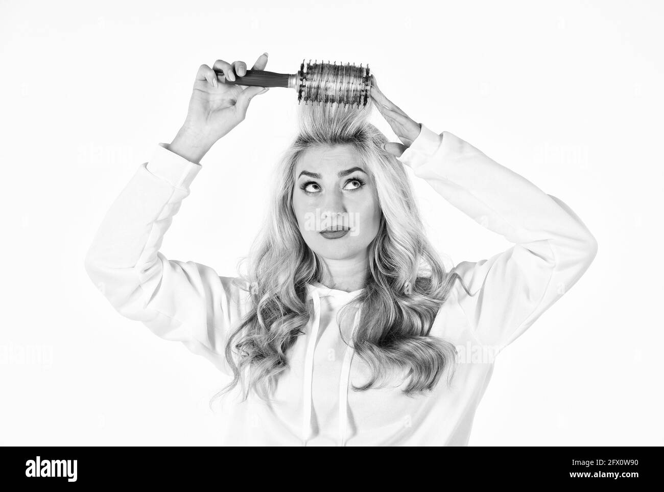 Pretty woman brushing hair isolated on white background. Long hair