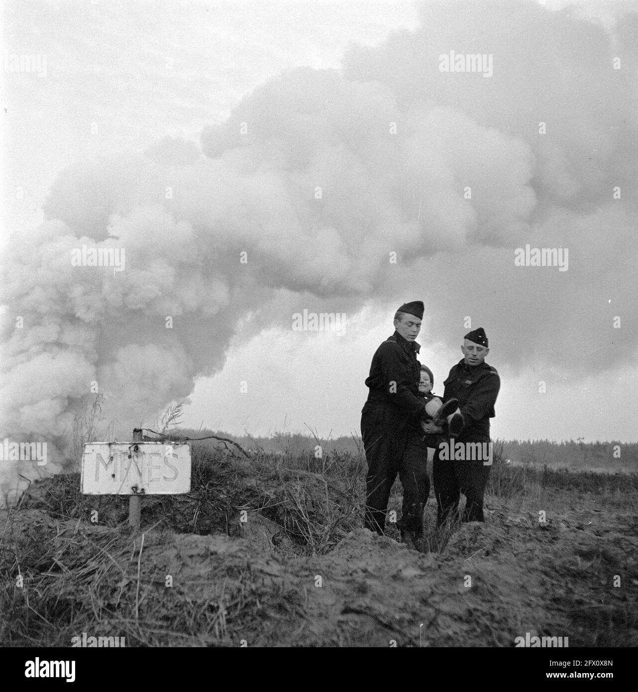 Southern Netherlands. Reportage on the dangers of mines and abandoned ammunition to playing children. Speeches by fire department and police to the children. Enscenations of accidents, December 24, 1945, Children, RIJKSPOLITIE, The Netherlands, 20th century press agency photo, news to remember, documentary, historic photography 1945-1990, visual stories, human history of the Twentieth Century, capturing moments in time Stock Photo