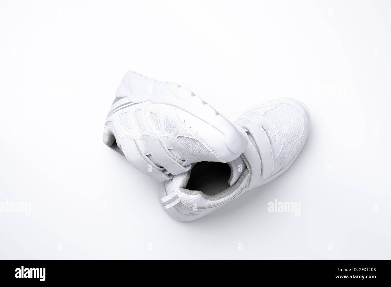 top view set of white unisex sneakers symbol of healthy sports habits and  health isolated on a white background Stock Photo - Alamy