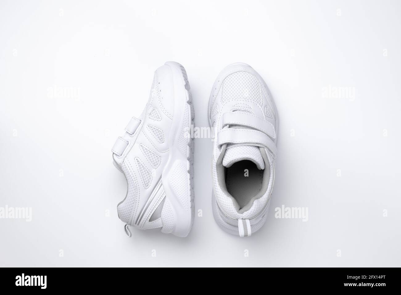 top view two white unisex sneakers, one sneaker is on the side isolated on  a white background Stock Photo - Alamy
