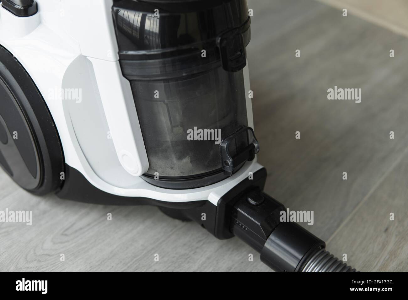 Bagless cyclone vacuum cleaner on a grey tile. Electrical apparatus ...