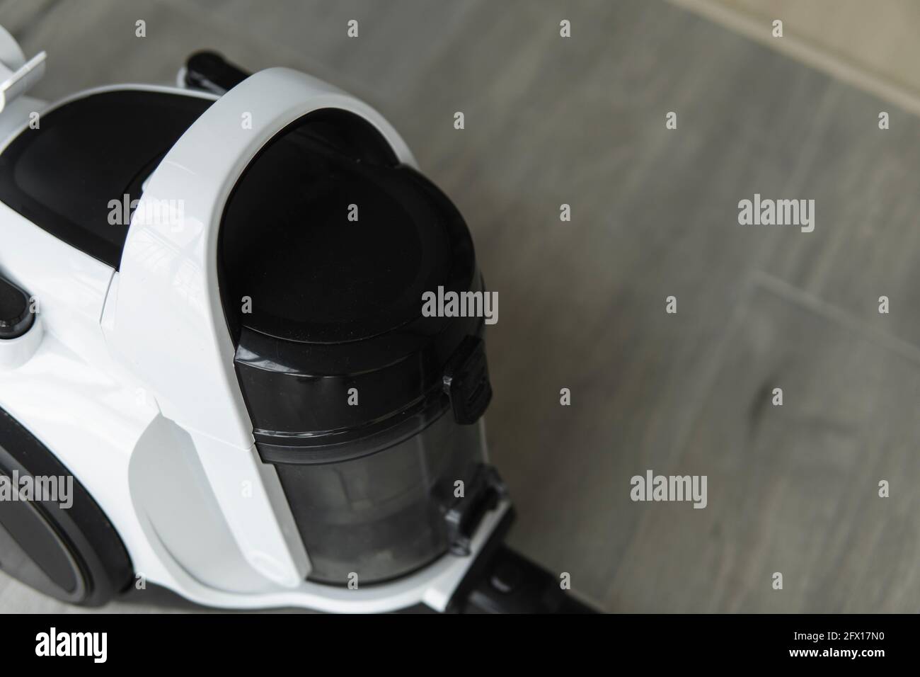 Bagless cyclone vacuum cleaner on a grey tile. Electrical apparatus ...