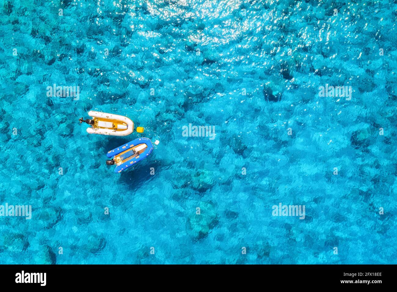 Aerial view of the boat in clear blue water at sunny day Stock Photo ...