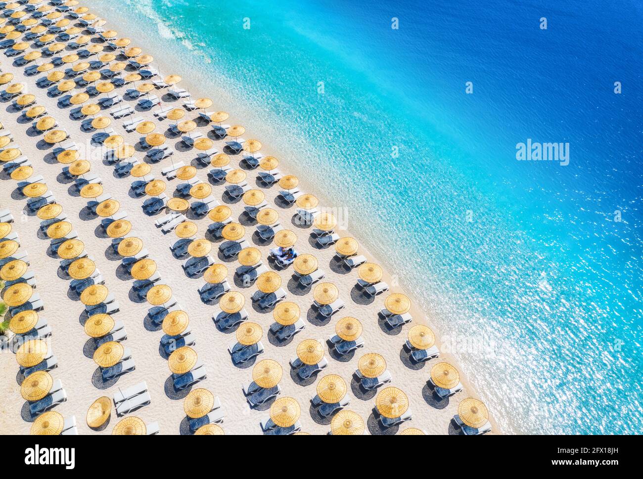 Aerial view of sea, empty sandy beach with sunbeds and umbrellas Stock Photo