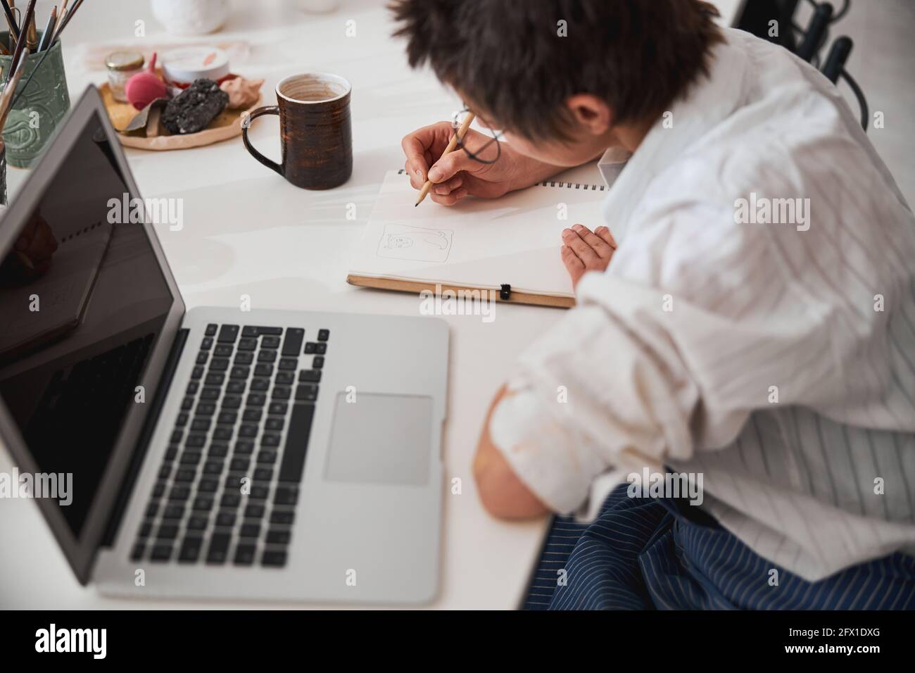Pot maker preparing drawing of planned clay figure Stock Photo Alamy